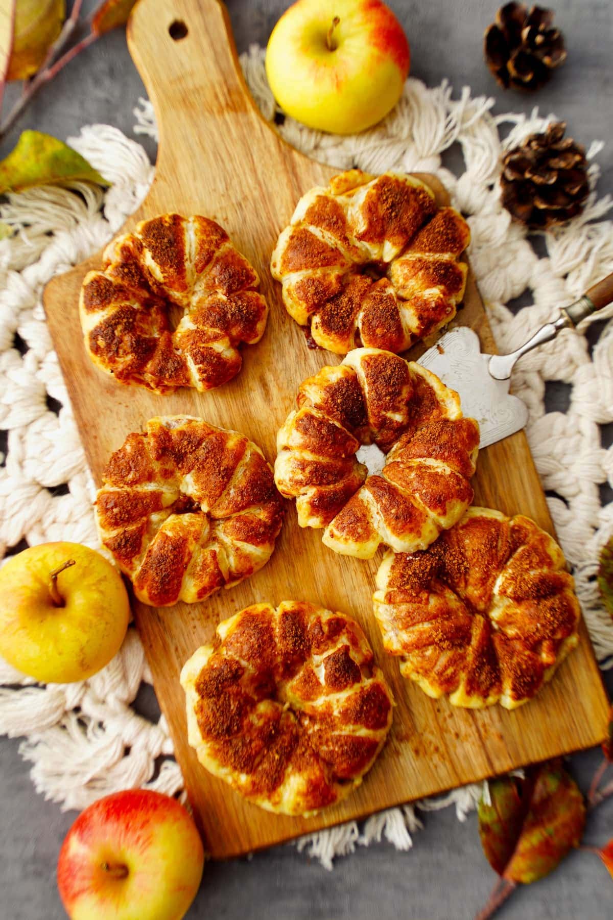 top shot of puff pastry apple rings on wooden board