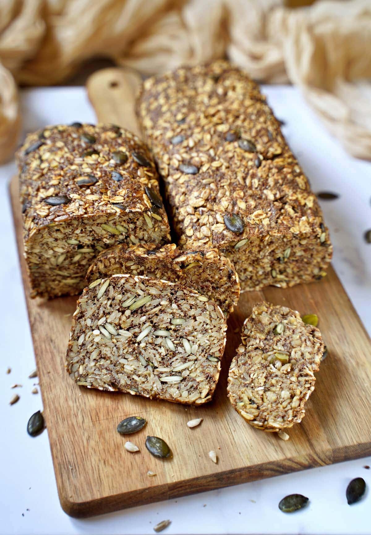 healthy gluten-free seed bread loaves on wooden board