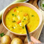 vegan potato and leek soup in bowl with spoon