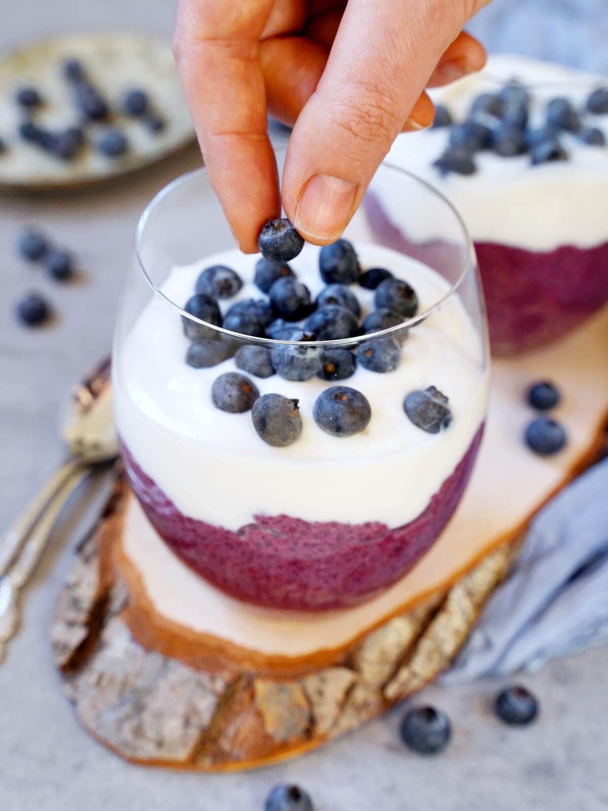 decorating pink pudding with yogurt and fresh blueberries