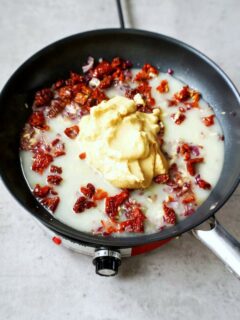 hummus and sun-dried tomatoes in skillet