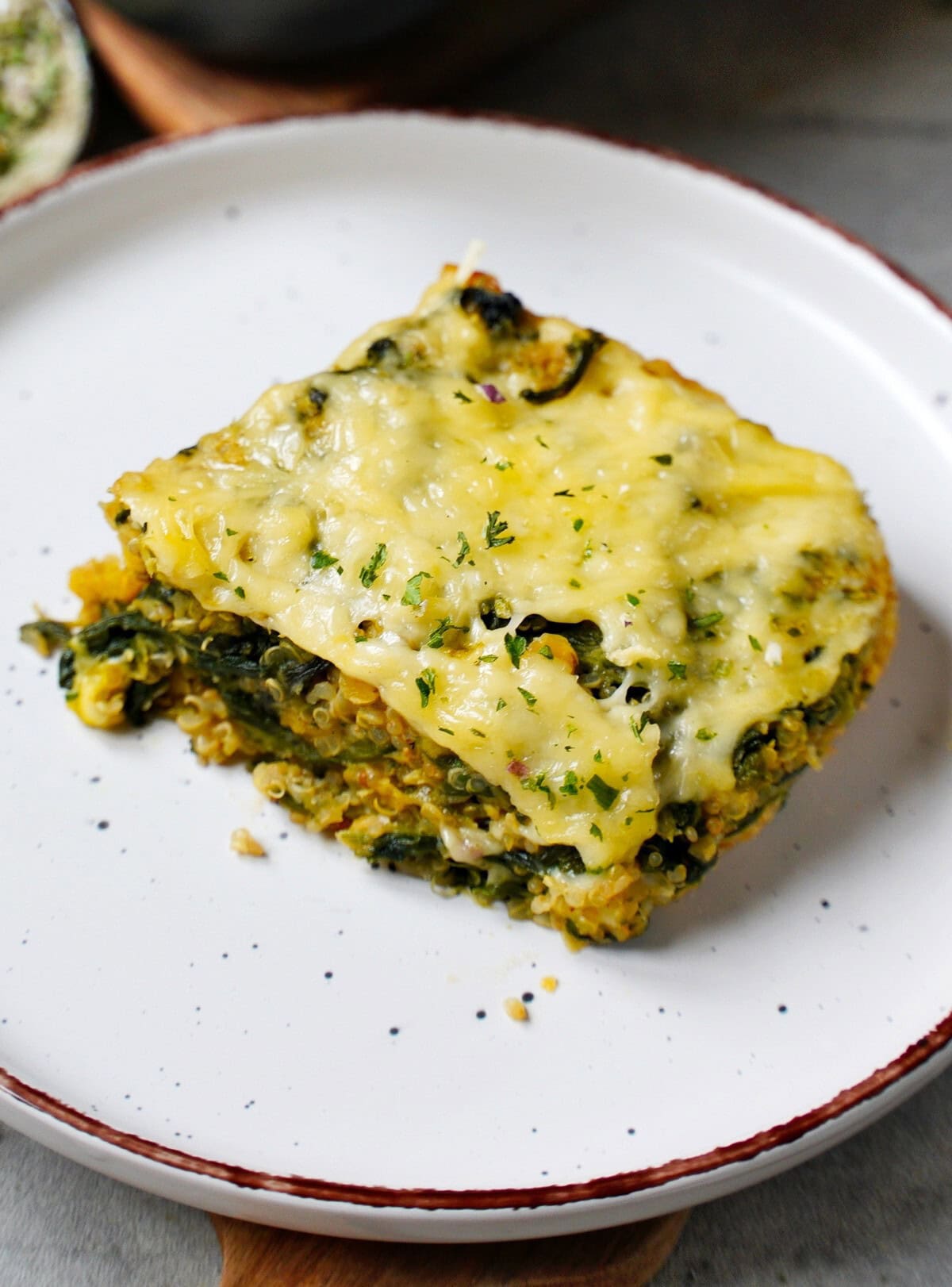 piece of spinach casserole with cheese on plate
