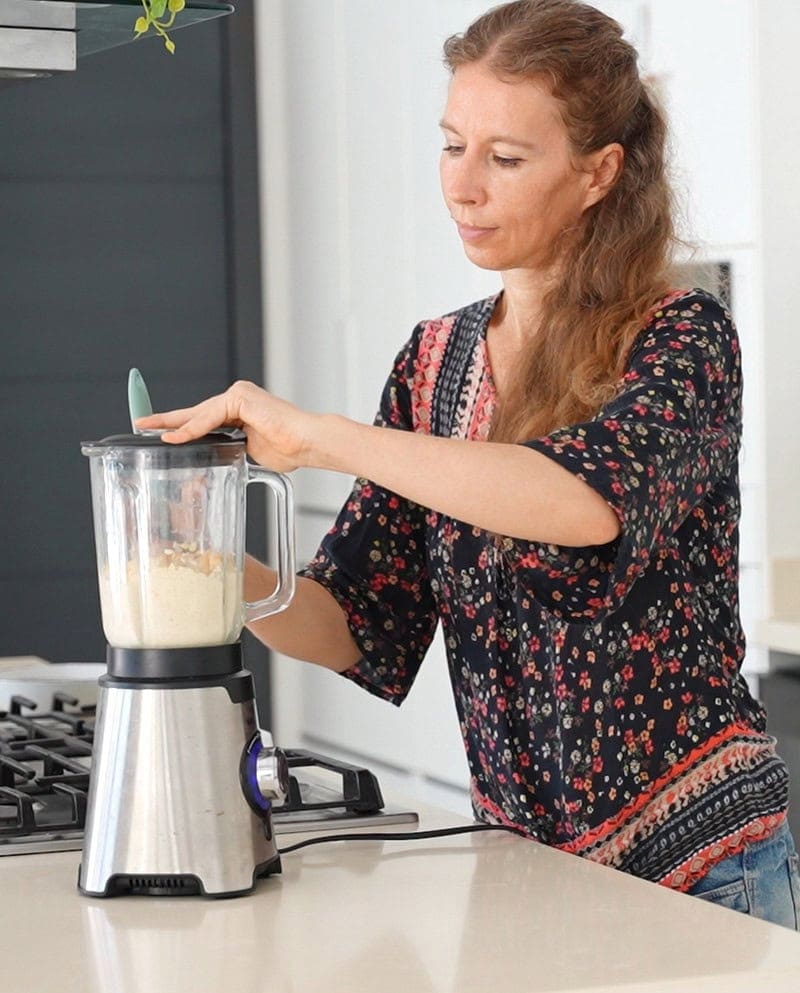 Michaela Vais uses a blender in a bright kitchen