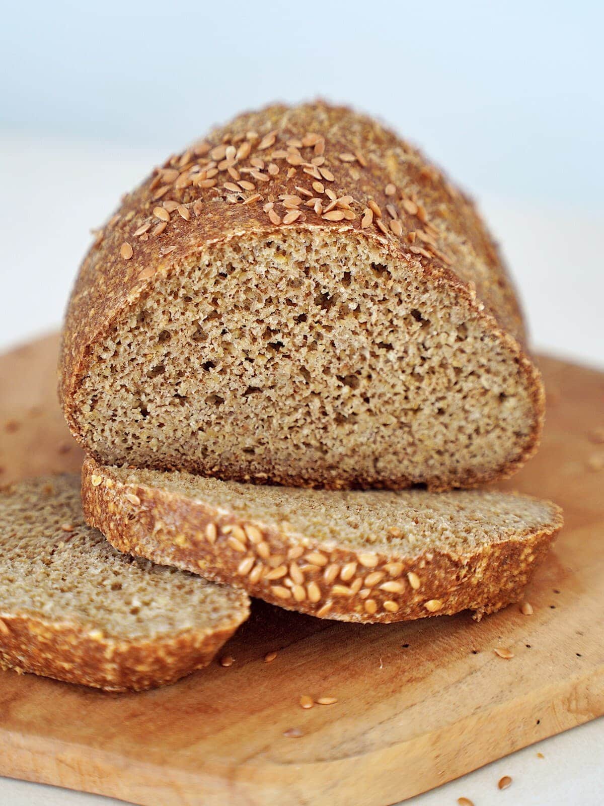 A freshly baked, round loaf of chickpea bread with flaxseeds