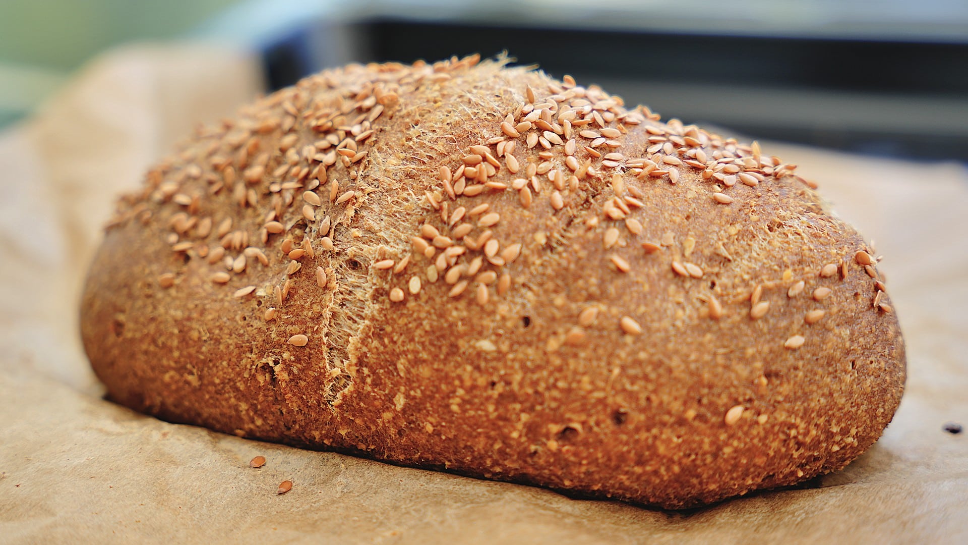 A rustic loaf of chickpea bread with a golden-brown crust