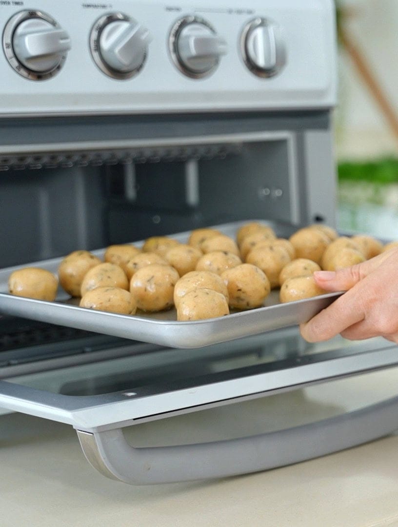 Potato balls in air fryer before baking