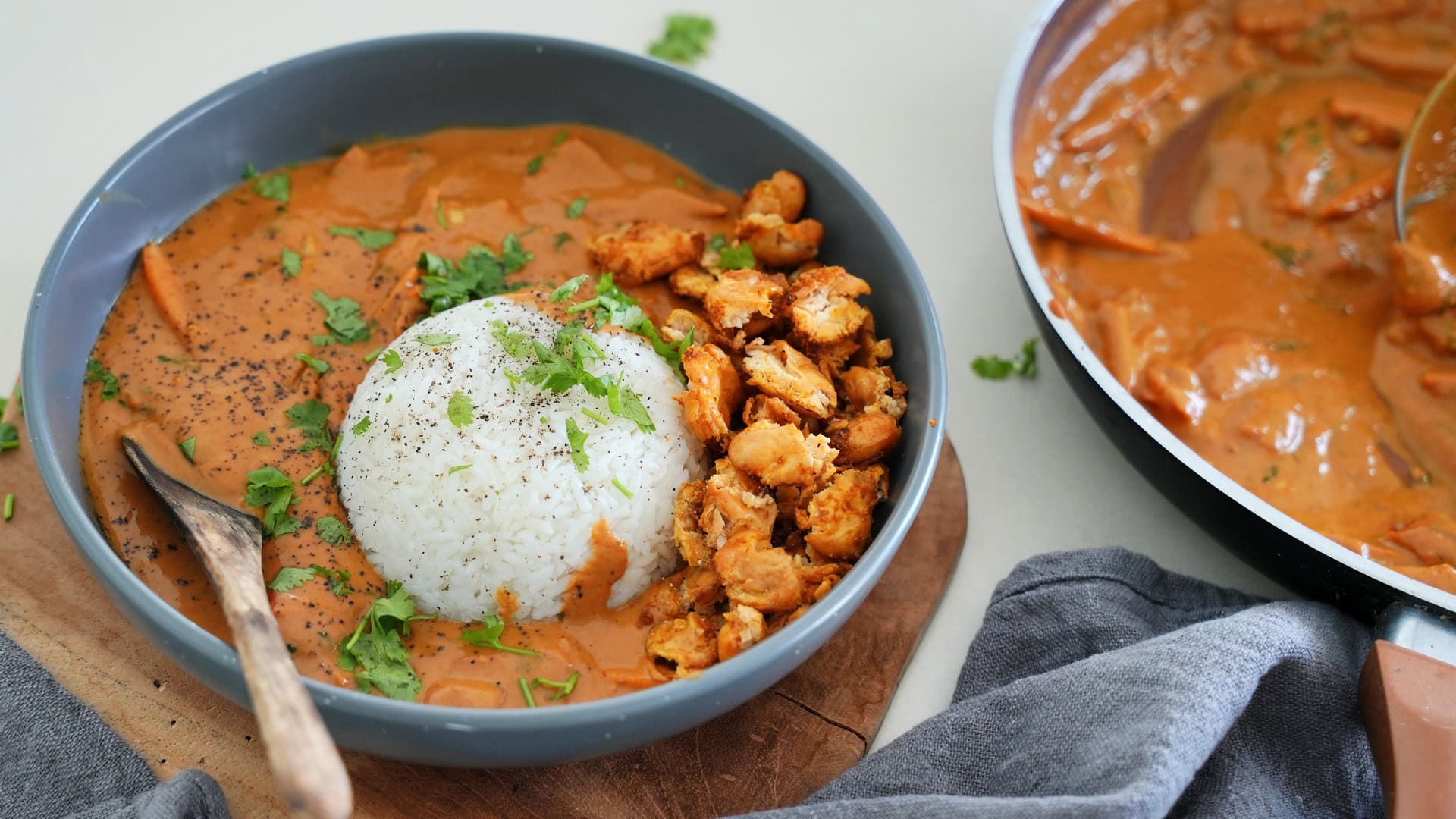 A bowl of creamy peanut curry with crispy butter beans