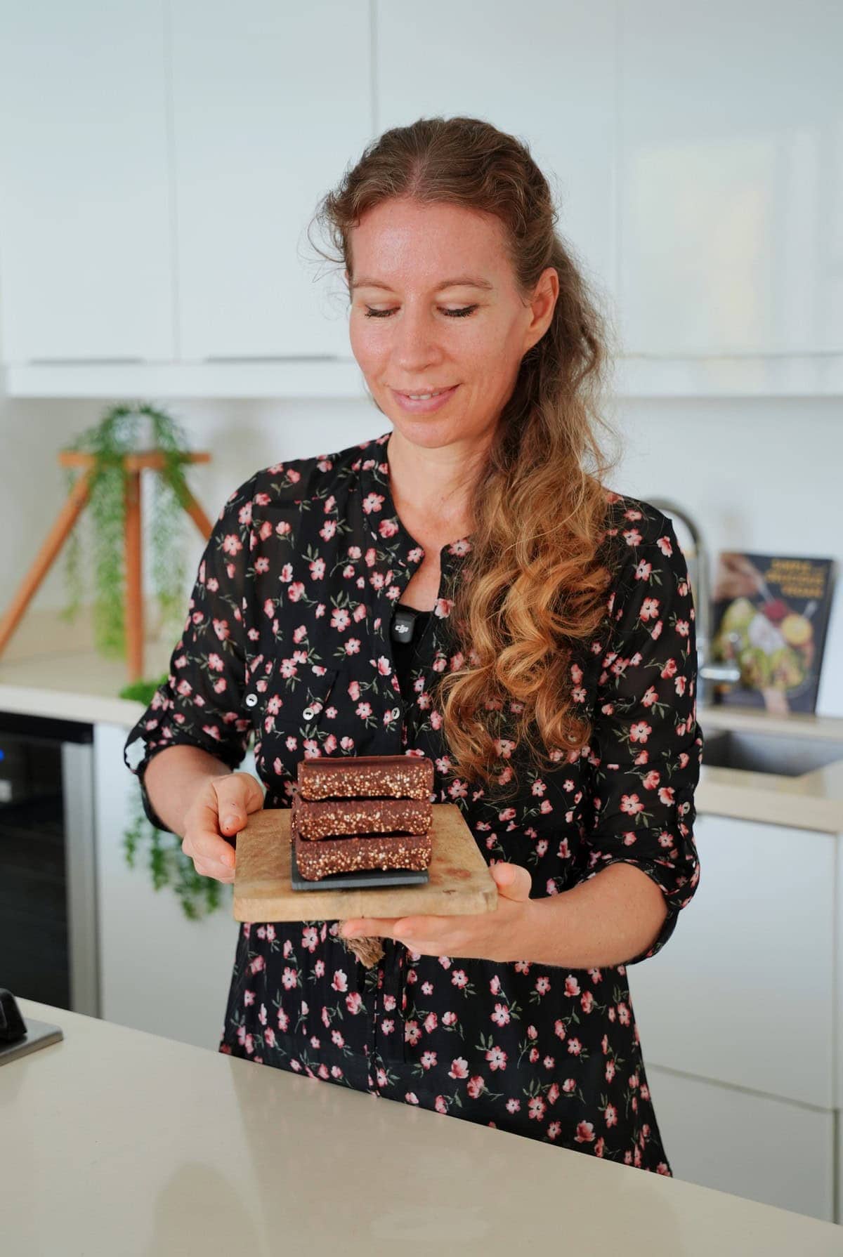 Michaela Vais holding crunchy chocolate quinoa bars.