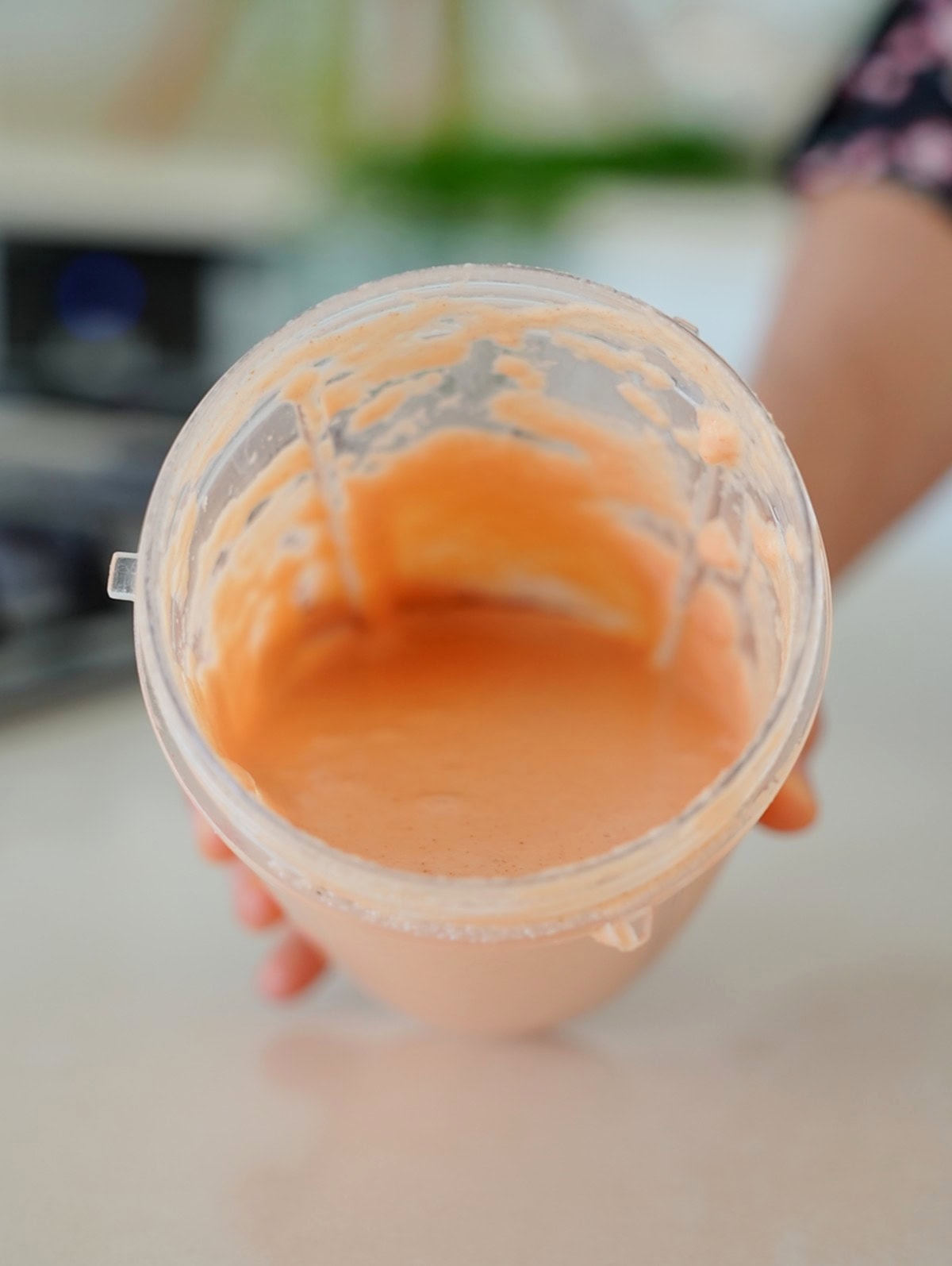 Blender jug fiilled with smooth red lentil waffle batter