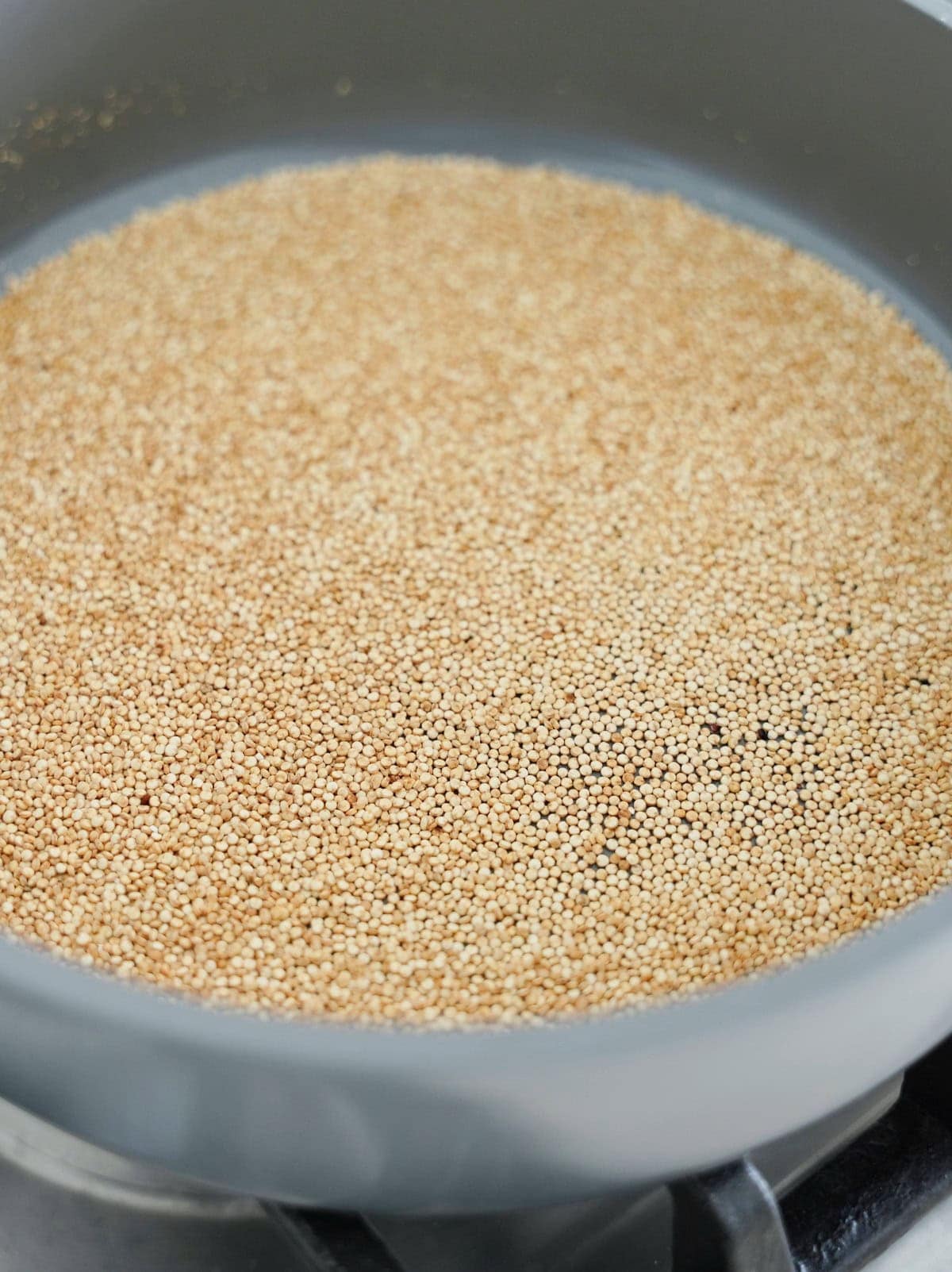 toasting quinoa in a pan