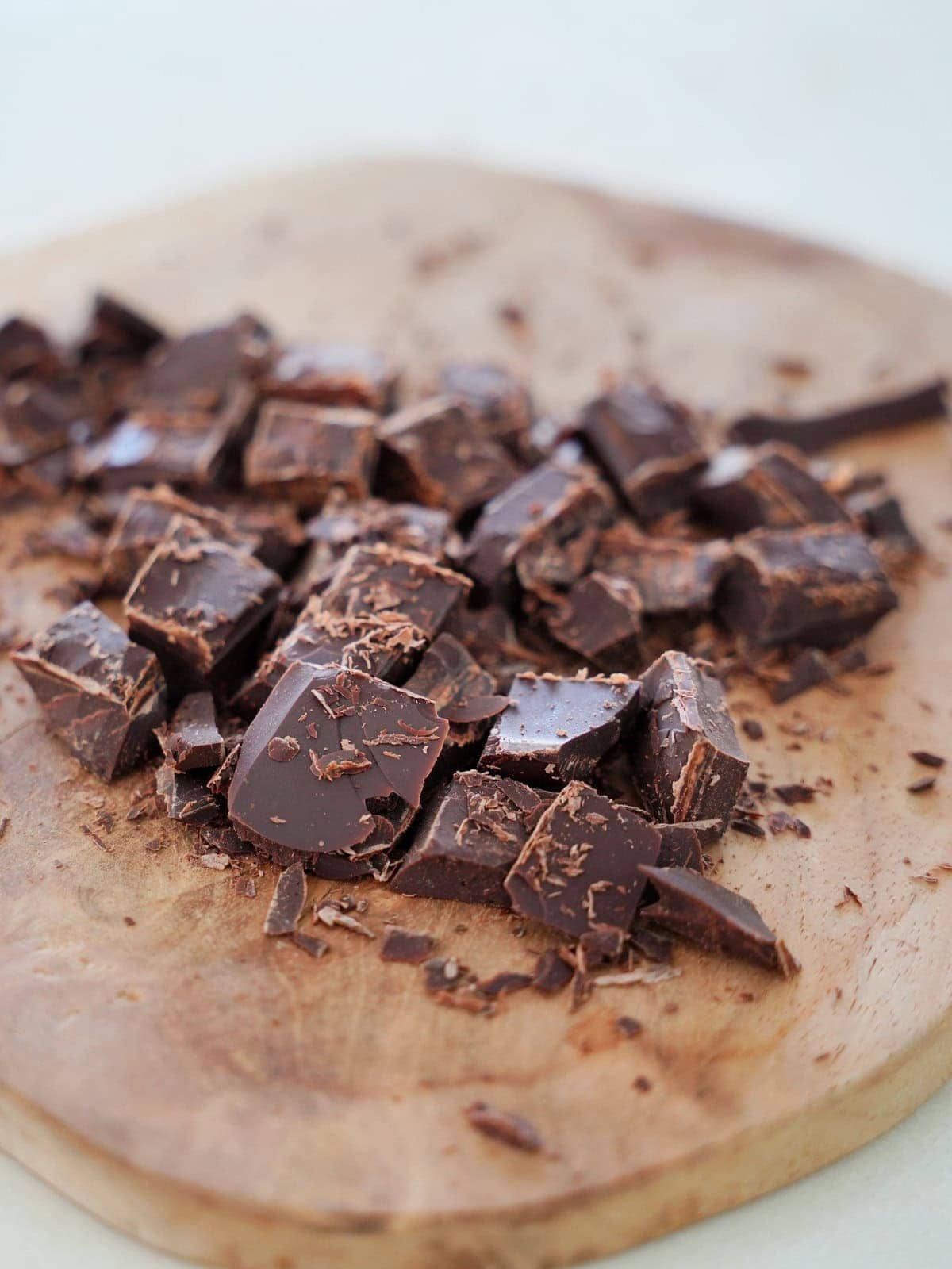 chopped chocolate on wooden board.