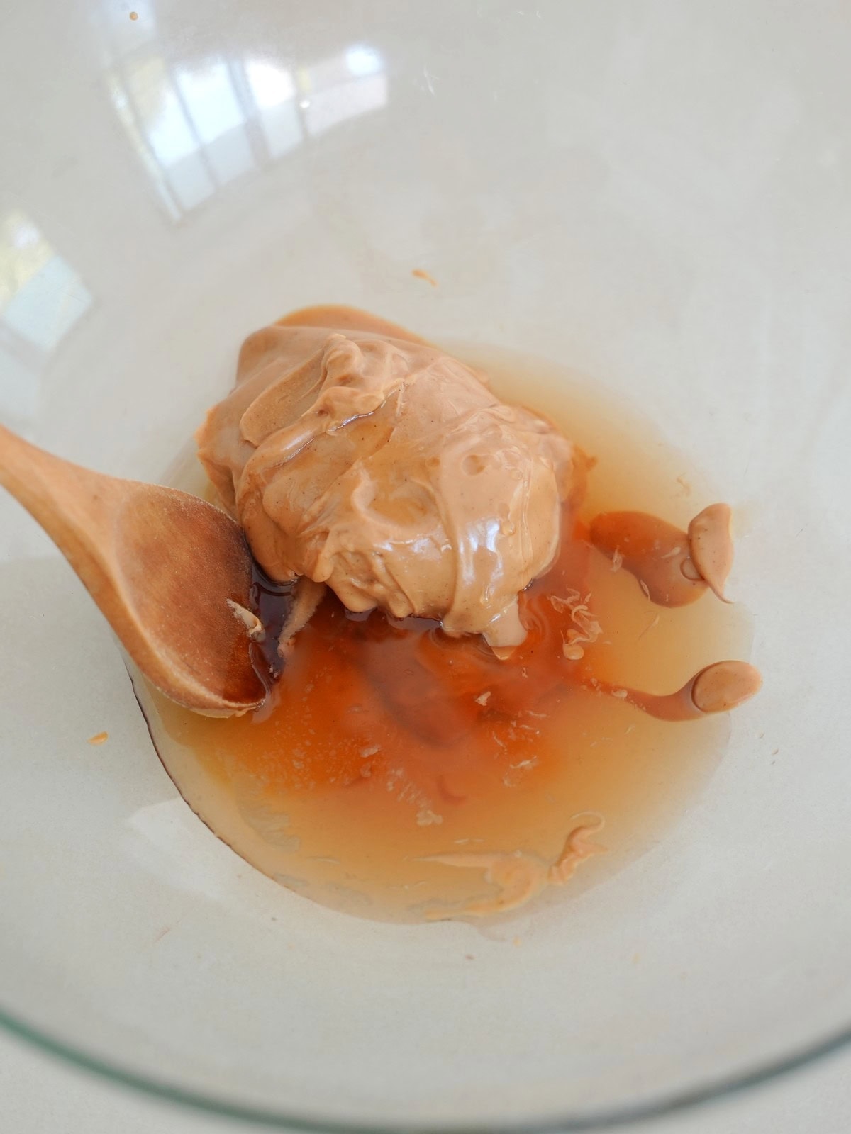 creamy peanut butter and maple syrup in glass bowl