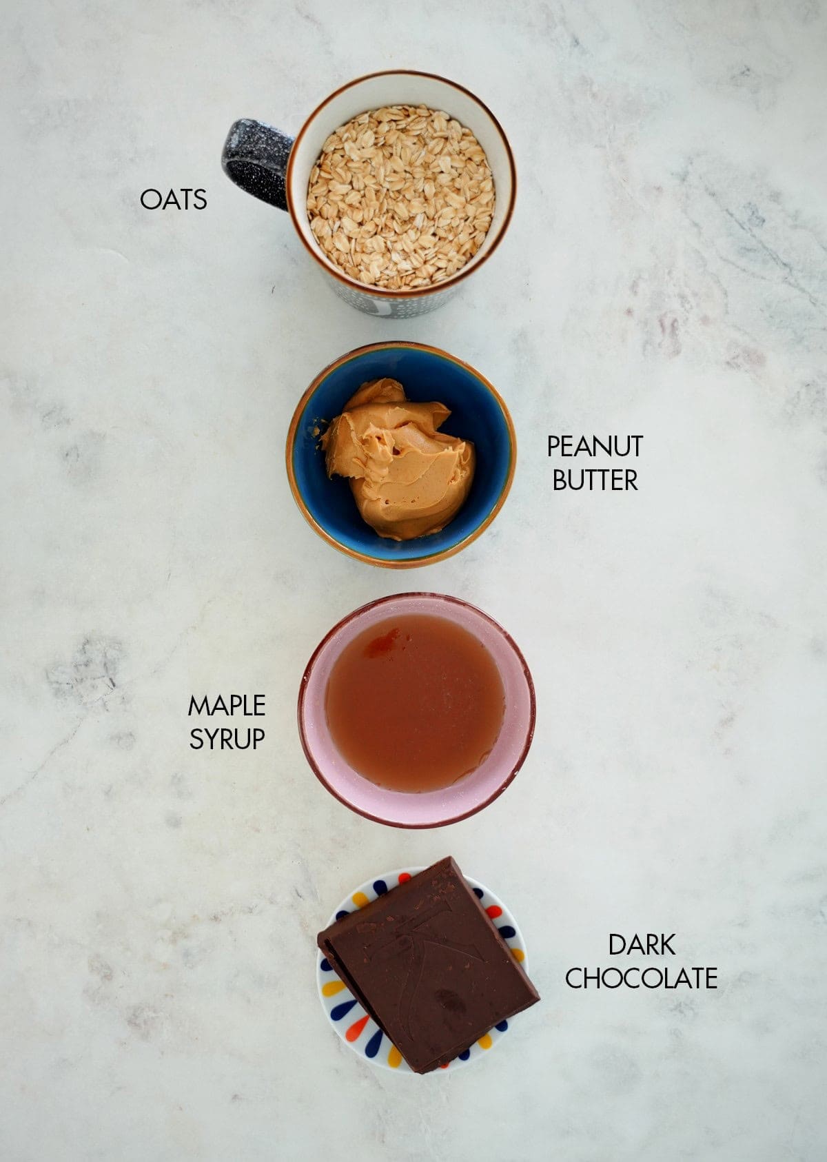 ingredients for peanut butter oat bars in small bowls.