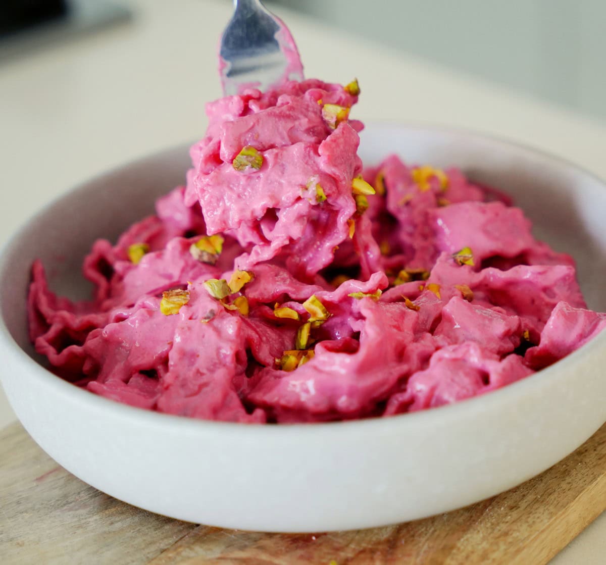 A close up bowl of Barbie pasta with crushed pistachios