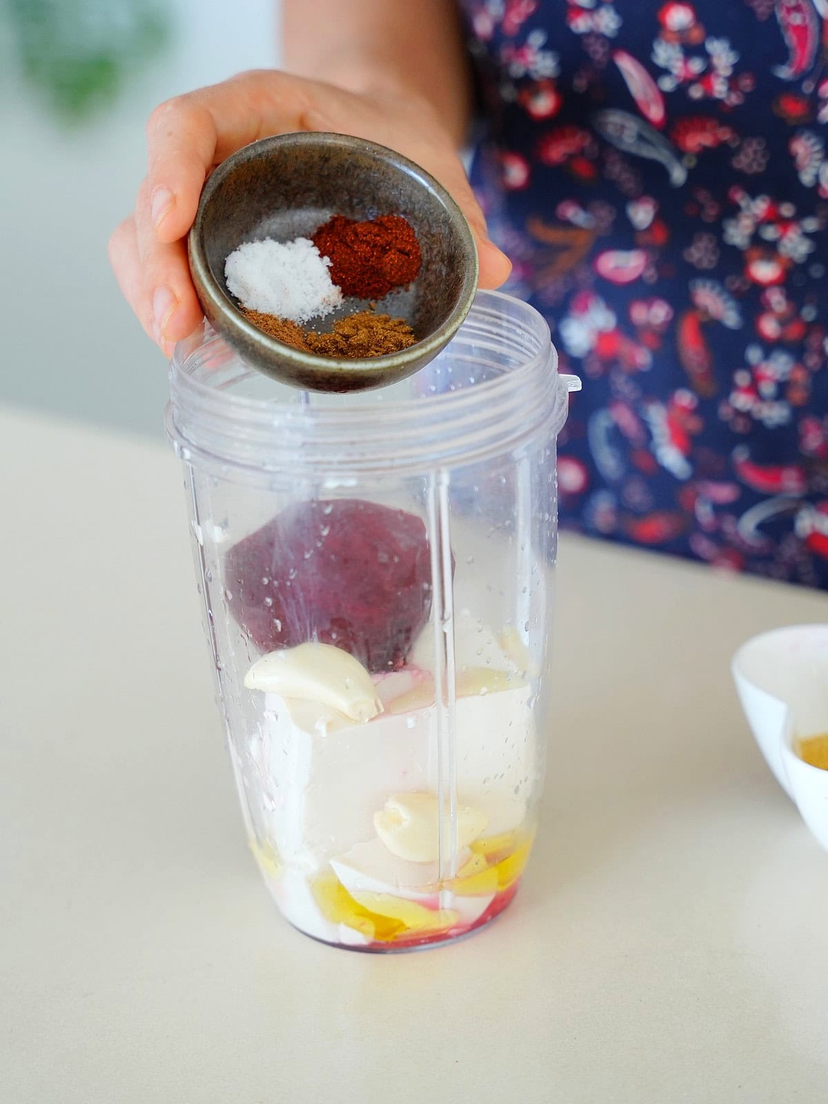 Adding sauce ingredients to a blender jug