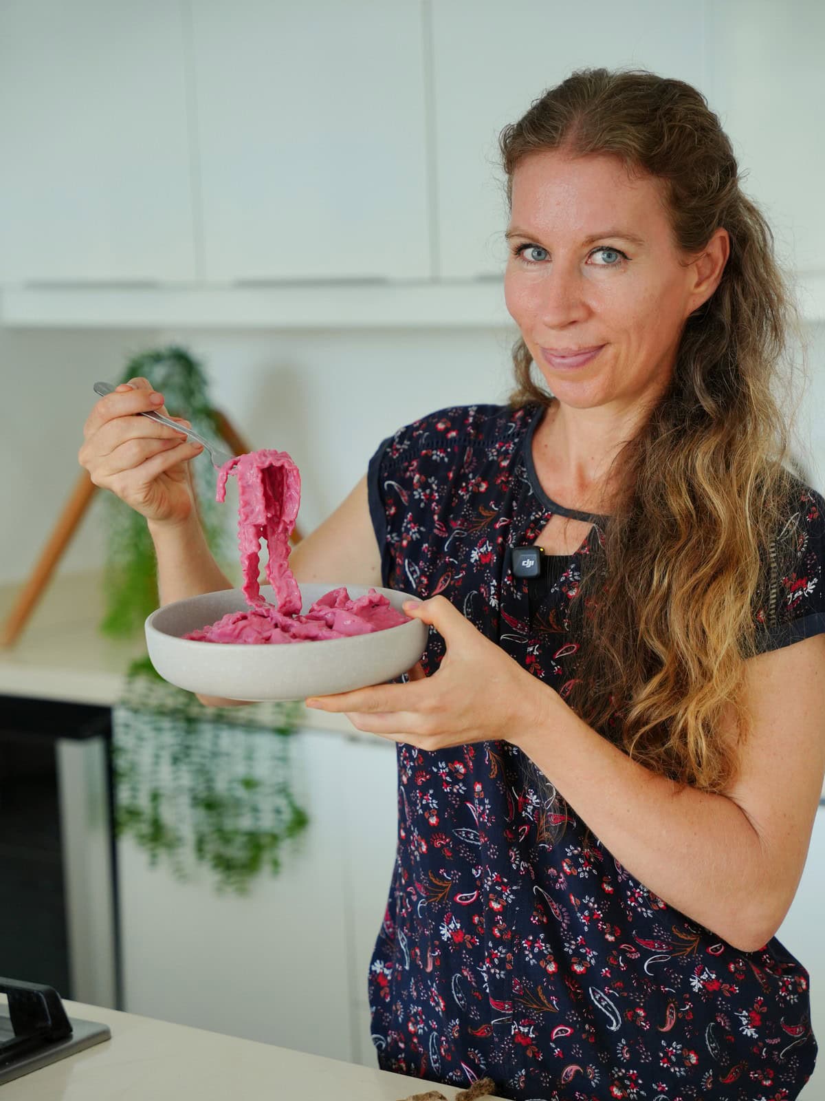 Michaela Vais holding a bowl of beetroot noodles