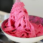 Pasta noodles tossed in bright pink beetroot pasta sauce