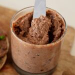 jar with vegan liverwurst and a knife.
