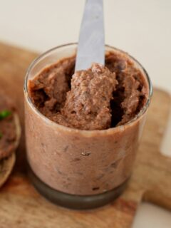 jar with vegan liverwurst and a knife.