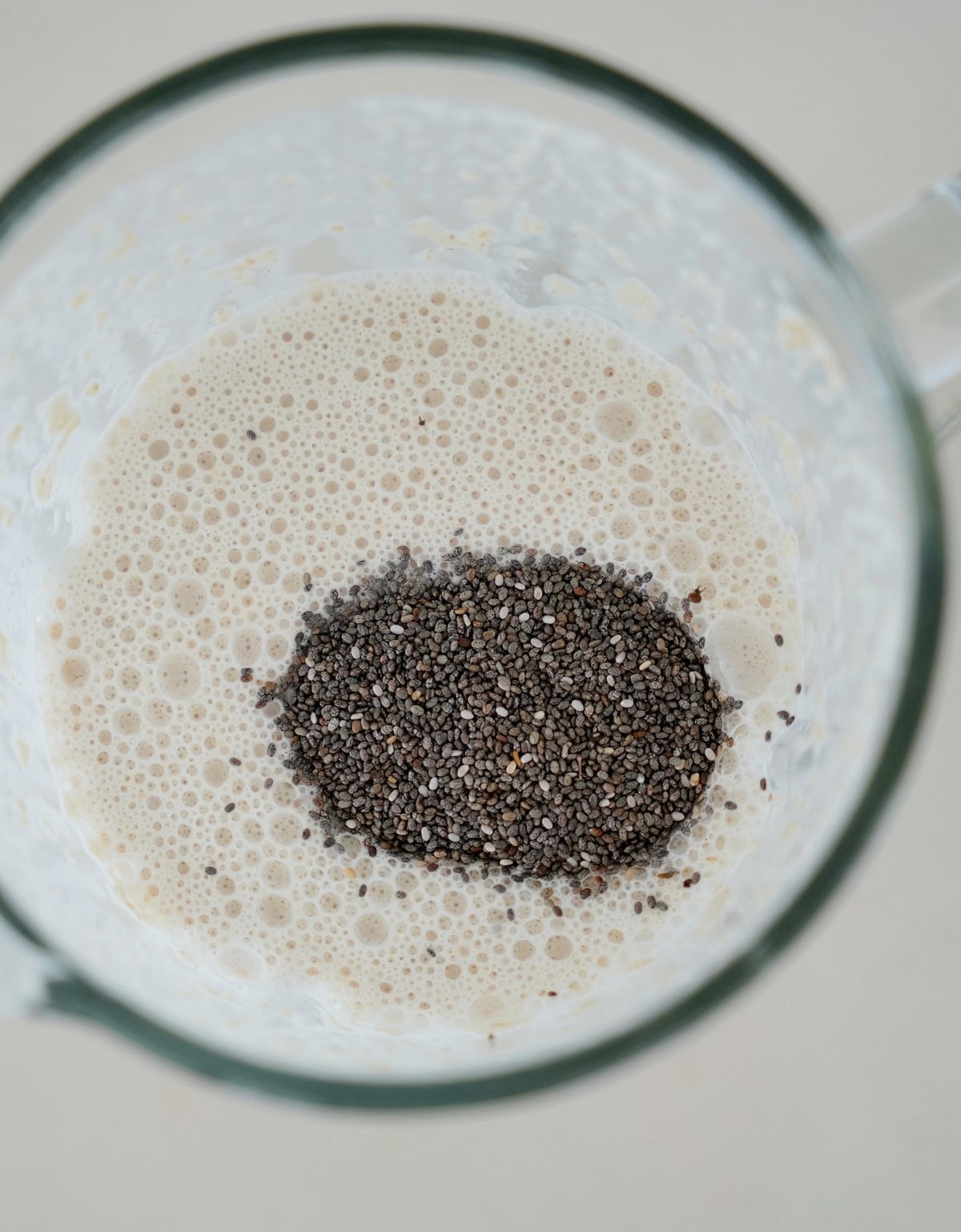 white batter with chia seeds in blender jug