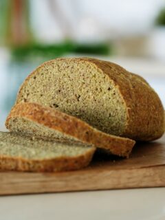 Sliced green pea bread on wooden board