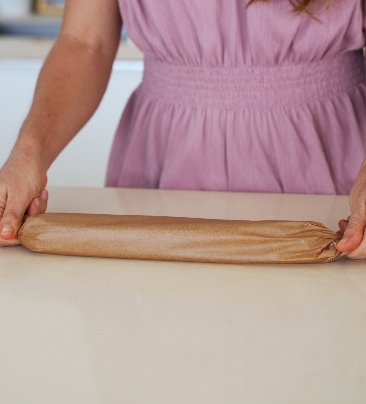 log of plant-based salami wrapped in parchment paper