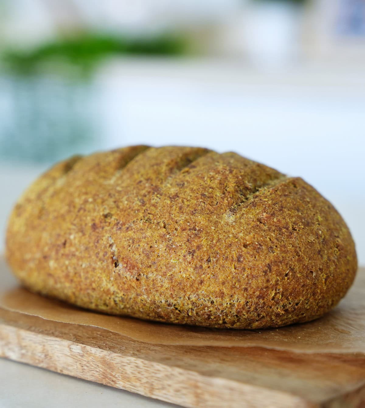 whole loaf of pea bread on wooden board